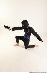 Man Young Athletic Fighting with gun Kneeling poses Casual Asian